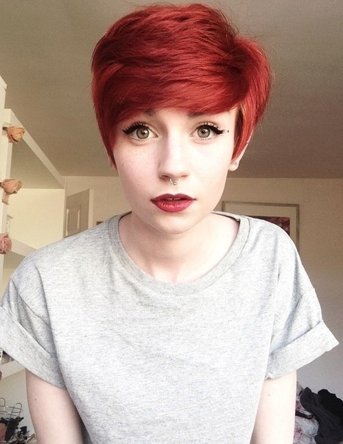 Red pixie haircut with side-swept bangs