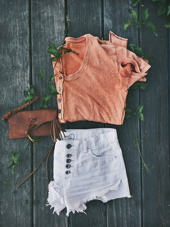 Orange top and pale shorts over