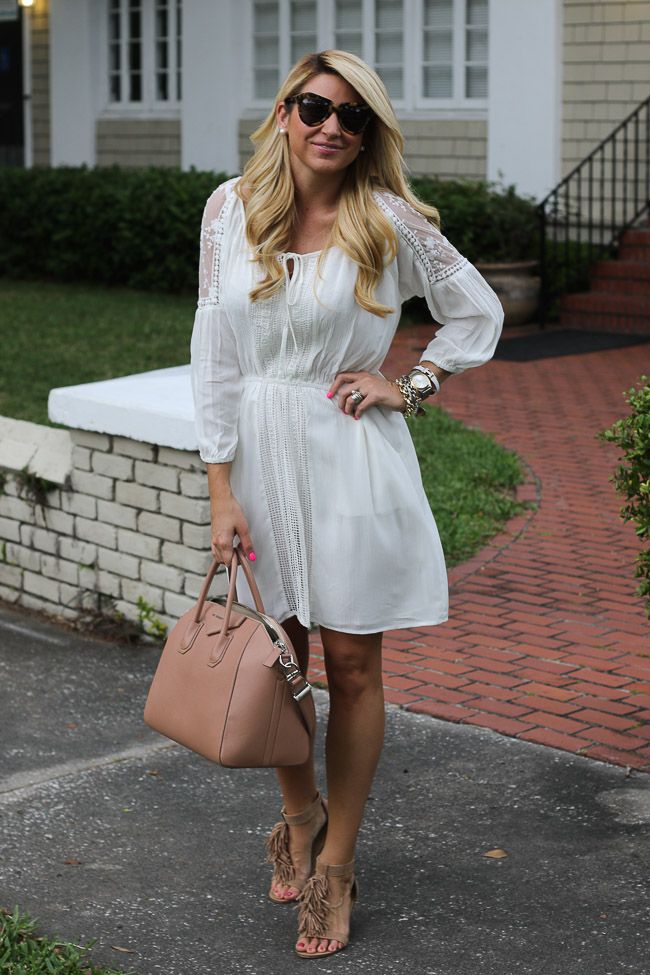 White dress, brown fringed sandals and brown bag