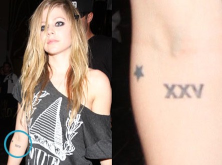 Avril Lavigne Tattoos - Star and XXV Right Elbow Tattoos
