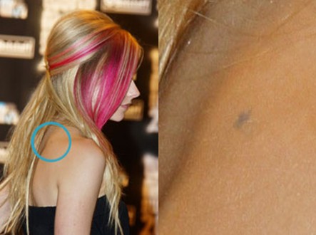 Avril Lavigne Tattoos - tiny star tattoo on the back