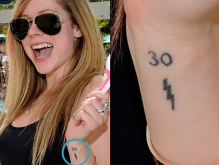 Avril Lavigne Tattoos - 30s and lightning tattoos on the left wrist