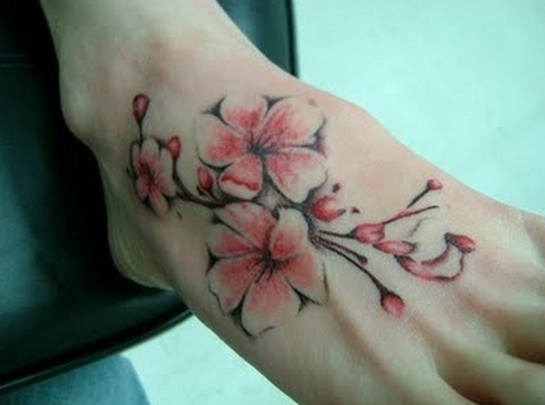 Foot tattoos designs for women: cherry blossom sakura tree blossom tattoo on foot
