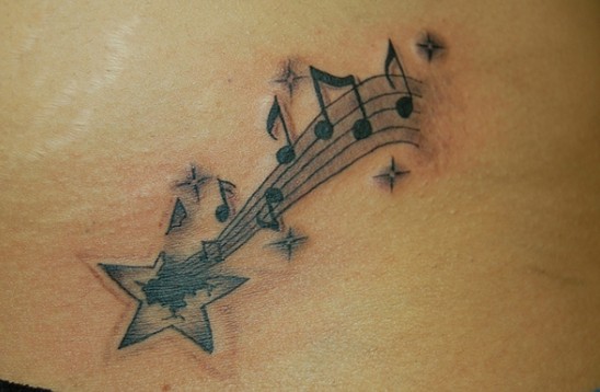 Star tattoo designs: shooting star with music notes tattoo