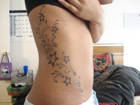 Star tattoo designs: flower star tattoo on the side of the body