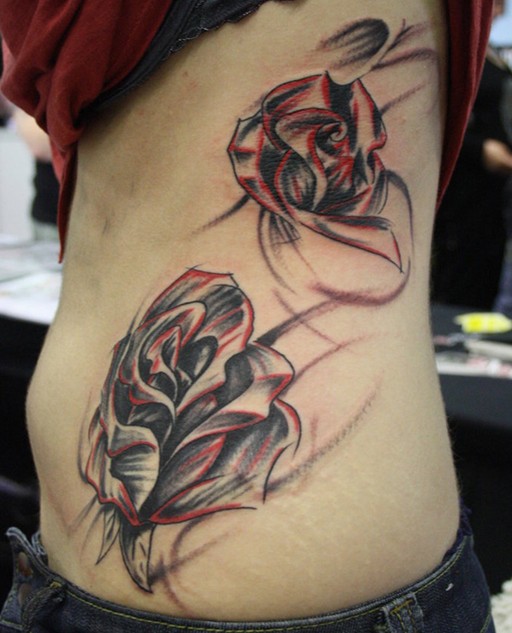 Rose tattoo on the side of the body