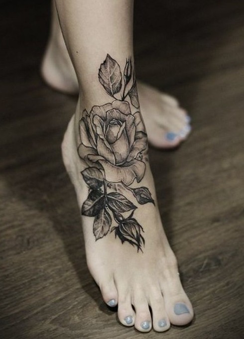 Black rose tattoo on foot