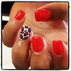 Red nails with leopard motifs