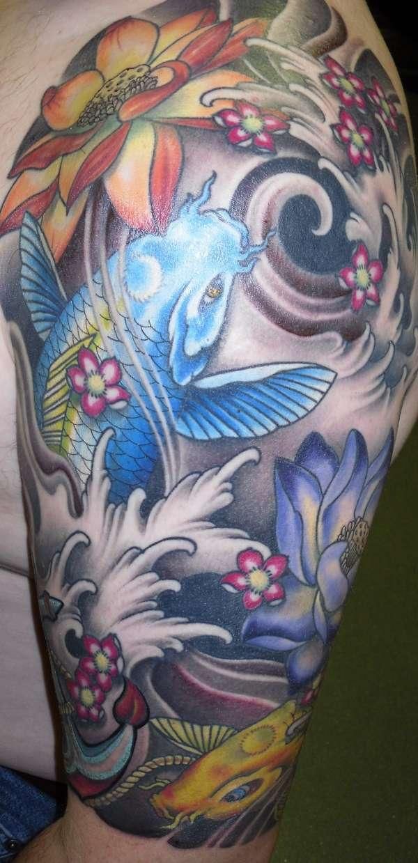 Fish and flower arm tattoo