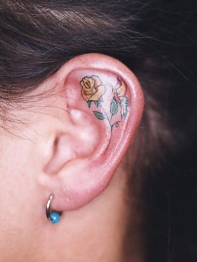 Flower inner ear tattoo