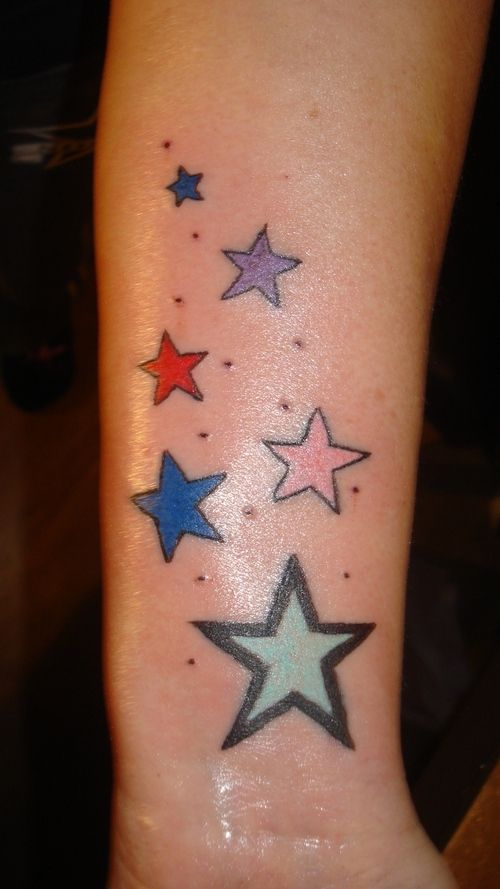 Colorful star tattoos on the wrist