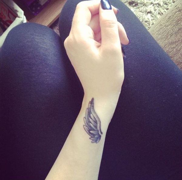 Angled wing tattoo on the wrist