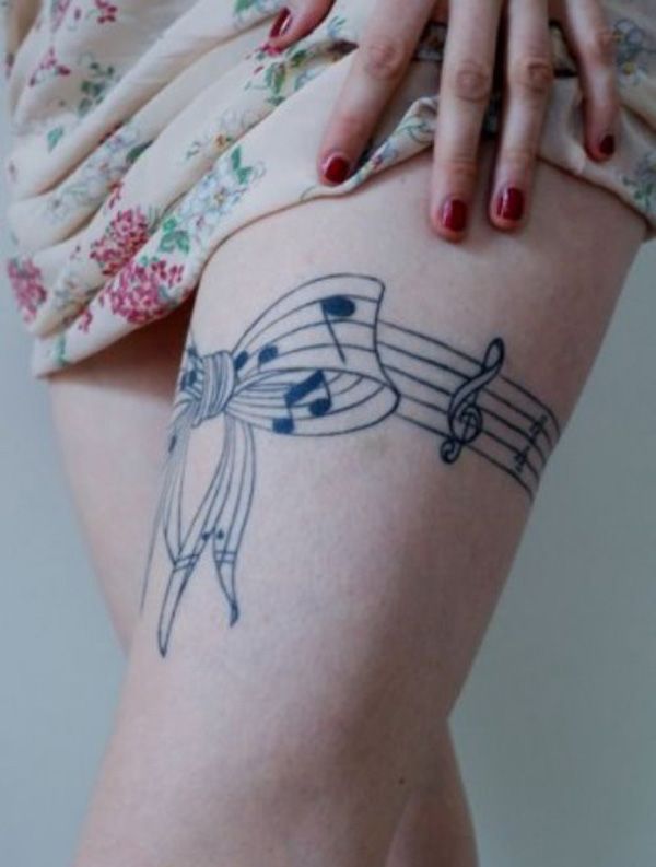 Music tattoo on the thigh