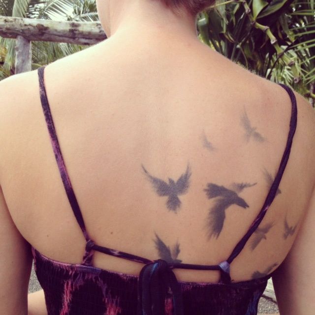 Pretty bird tattoo on the back