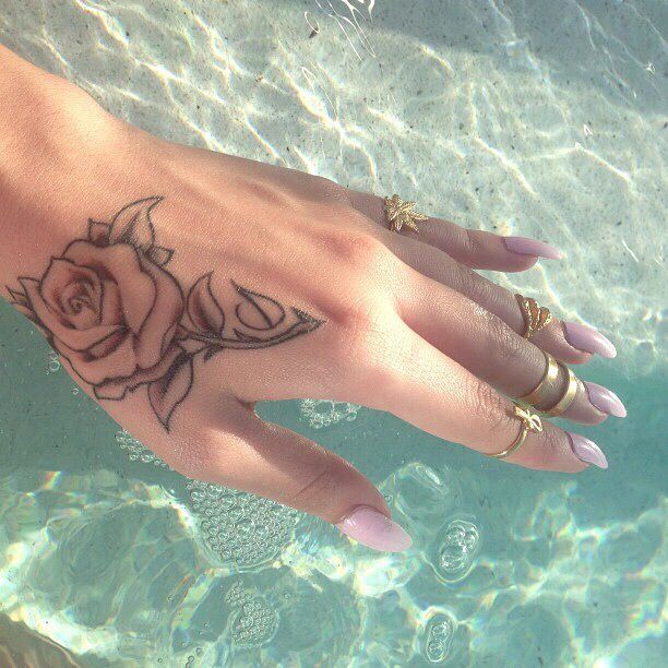 Women rose hand tattoo