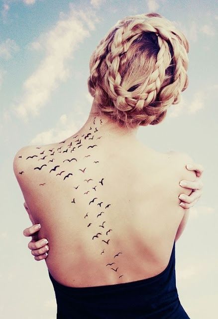 Simple bird tattoo on the back