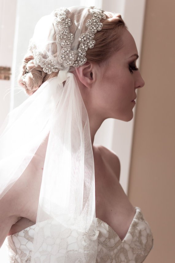 Bride updo hairstyle with veil and hair pieces