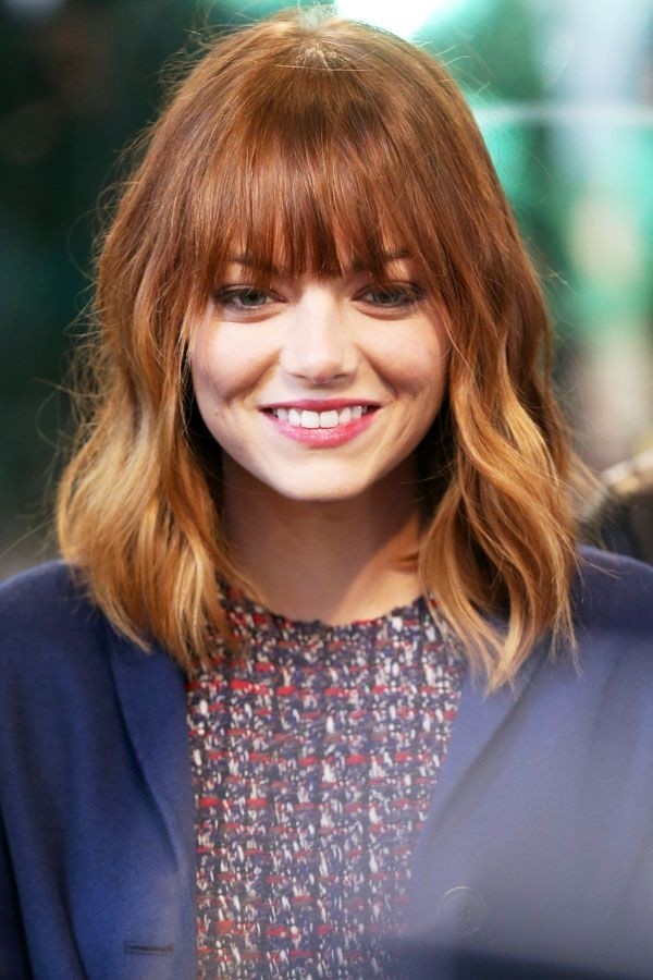 Emma Stone Medium hairstyle with blunt bangs Getty Images