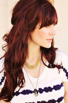 Dark red wavy hairstyle with blunt bangs