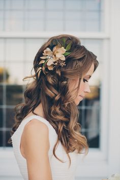 Half up half down wedding hairstyle with flower needle