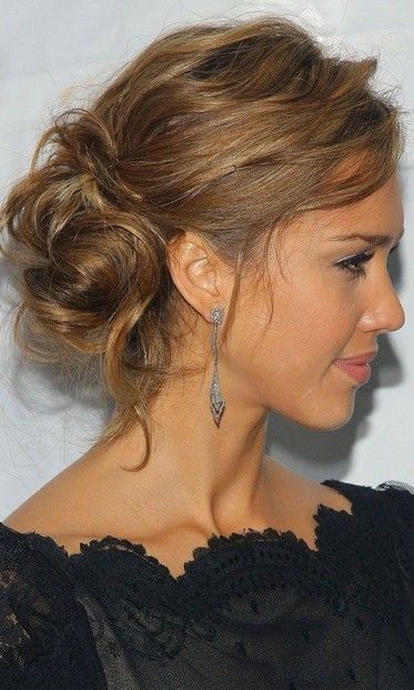 Messy bun hairstyle swept to the side