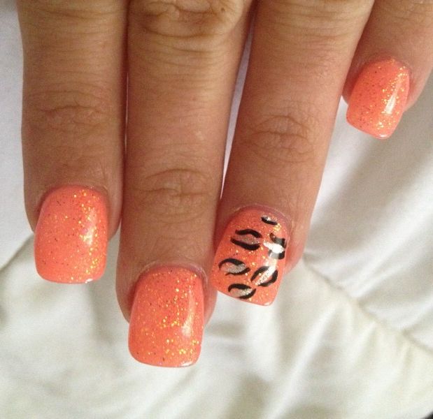 Orange nail design with leopard print