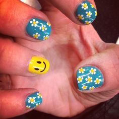 Happy face nail design with daisies