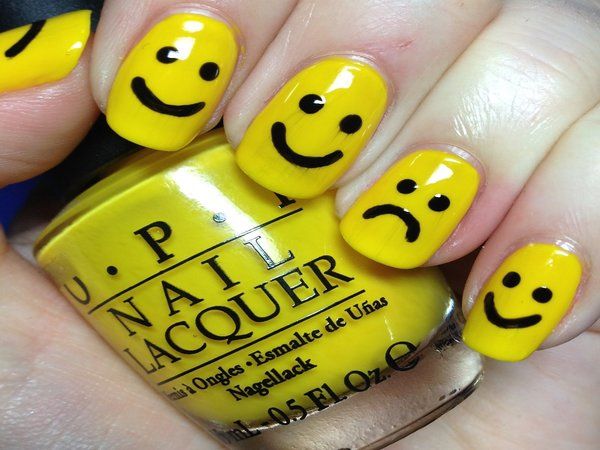 Luminous yellow happy face nail design