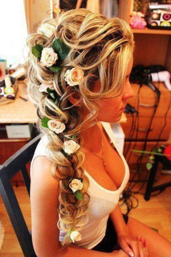 Fancy braided wedding hairstyle with flowers