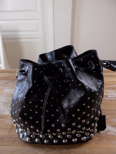 ALEXANDER MCQUEEN black studded leather bucket bag with skull .