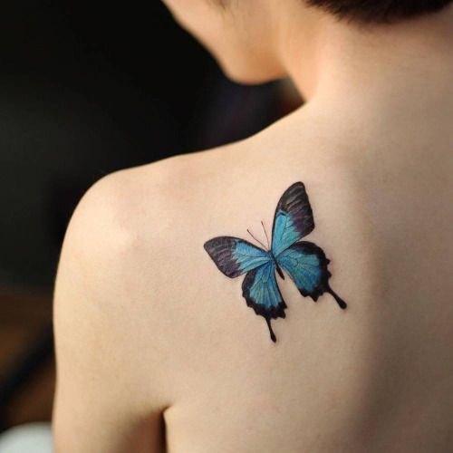 Small blue butterfly tattoo on the left shoulder blade. Tattoo .