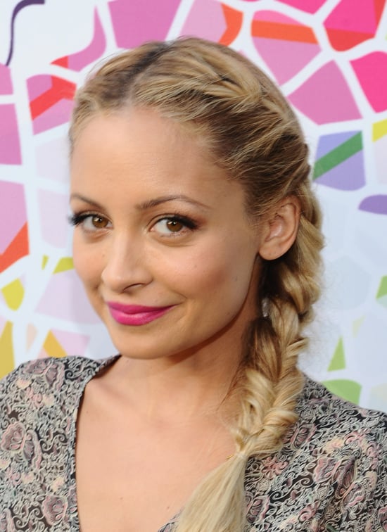 Her hot-pink lips and sweet French braids showed off her playful .