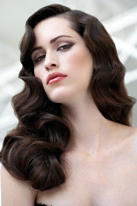 Vintage big curly hairstyles with side bangs for long hair .