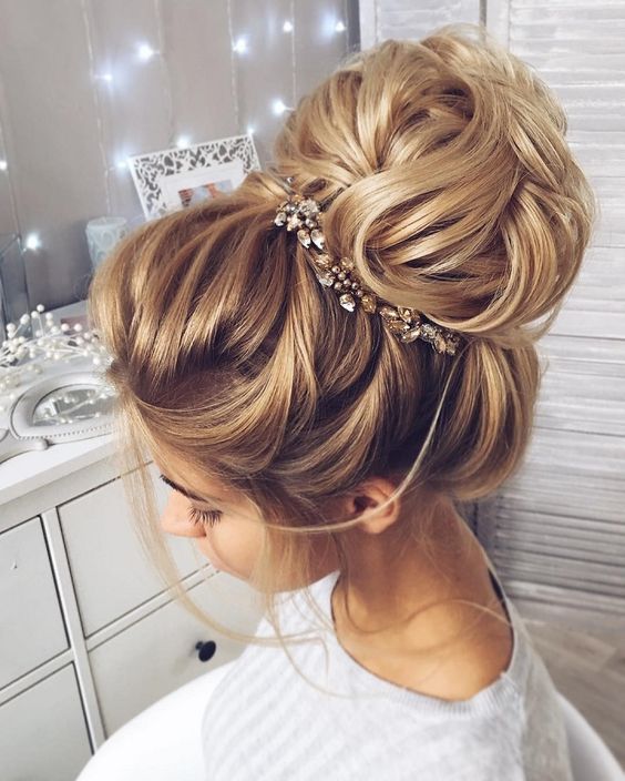 This beautiful high bun wedding hairstyle perfect for any wedding .