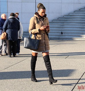 Gorgeous young woman in minidress, tights & boots overknee… | Flic